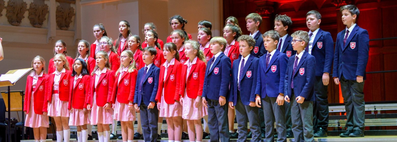 Children all stood in a row in the school hall