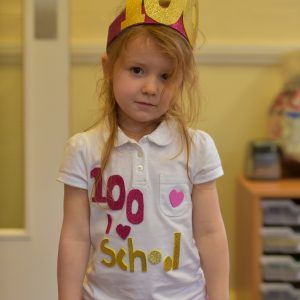 A red hair shcool girl dressed as a princess with a gold crown.