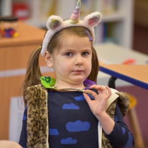 A child wearing a Unicorn headband.