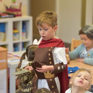 A small school boy wearing a Roman Centurion outfit.