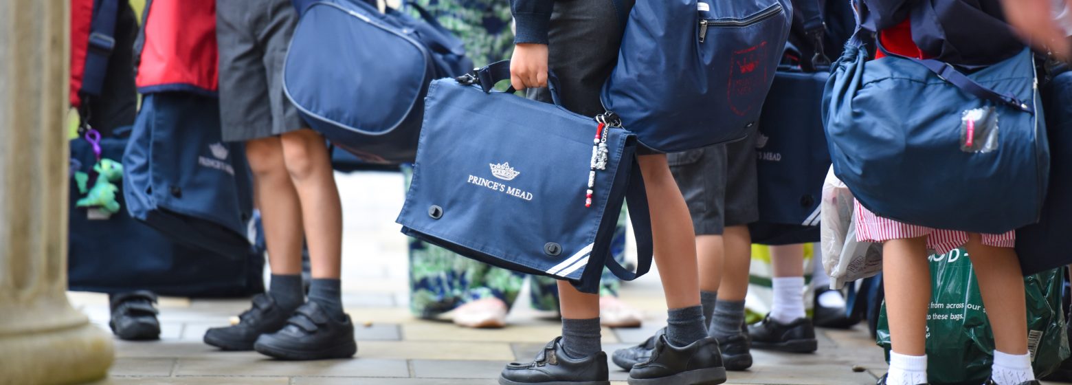 group of young children holding school bags