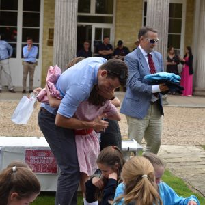 a teacher hugging a pupil on their last day