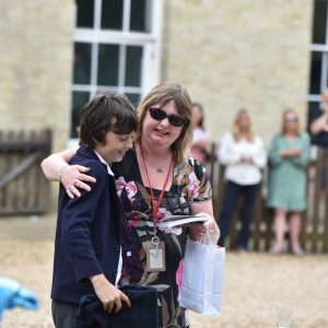 a teacher hugging a pupil