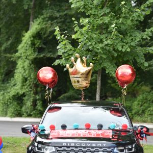 a crown balloon attached to a car