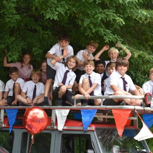 children from a prep school in Hampshire sitting on top of a party bus